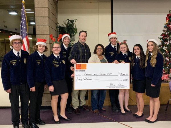 Lemoore High students with check L to R are FFA officers Garrett Stanley, Zach Wright Mendes, Jared Thompson, Janson Cunningham, Aliyah Johnson, Alisa Cuthbertson, Allison Rodrigues. Leprino employees are Ron Walker and Heidi Nunes.